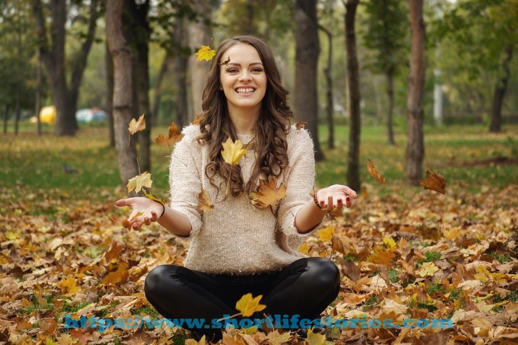 beautiful girl, in the park, throwing leaves